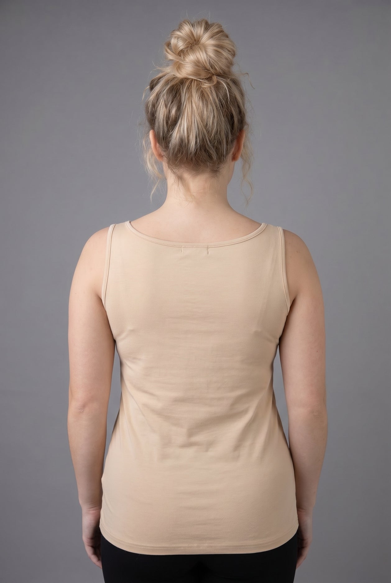 Model wearing Nuggles® Wide Neck Tank in Buff