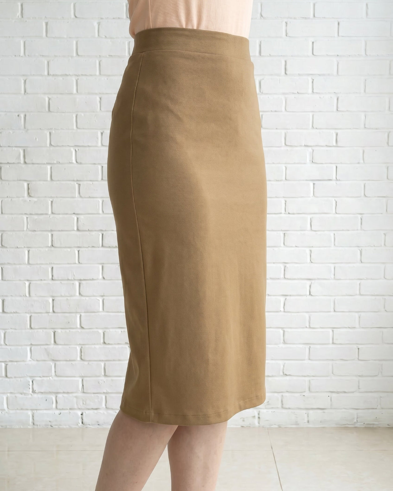 Model wearing Nuggles® 27" Relaxed Skirt in Camel
