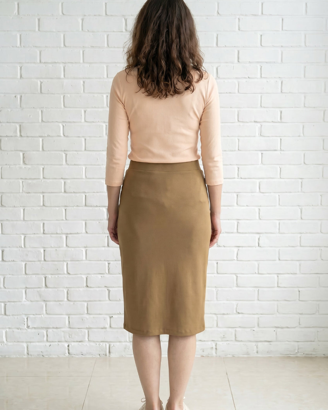Model wearing Nuggles® 27" Relaxed Skirt in Camel