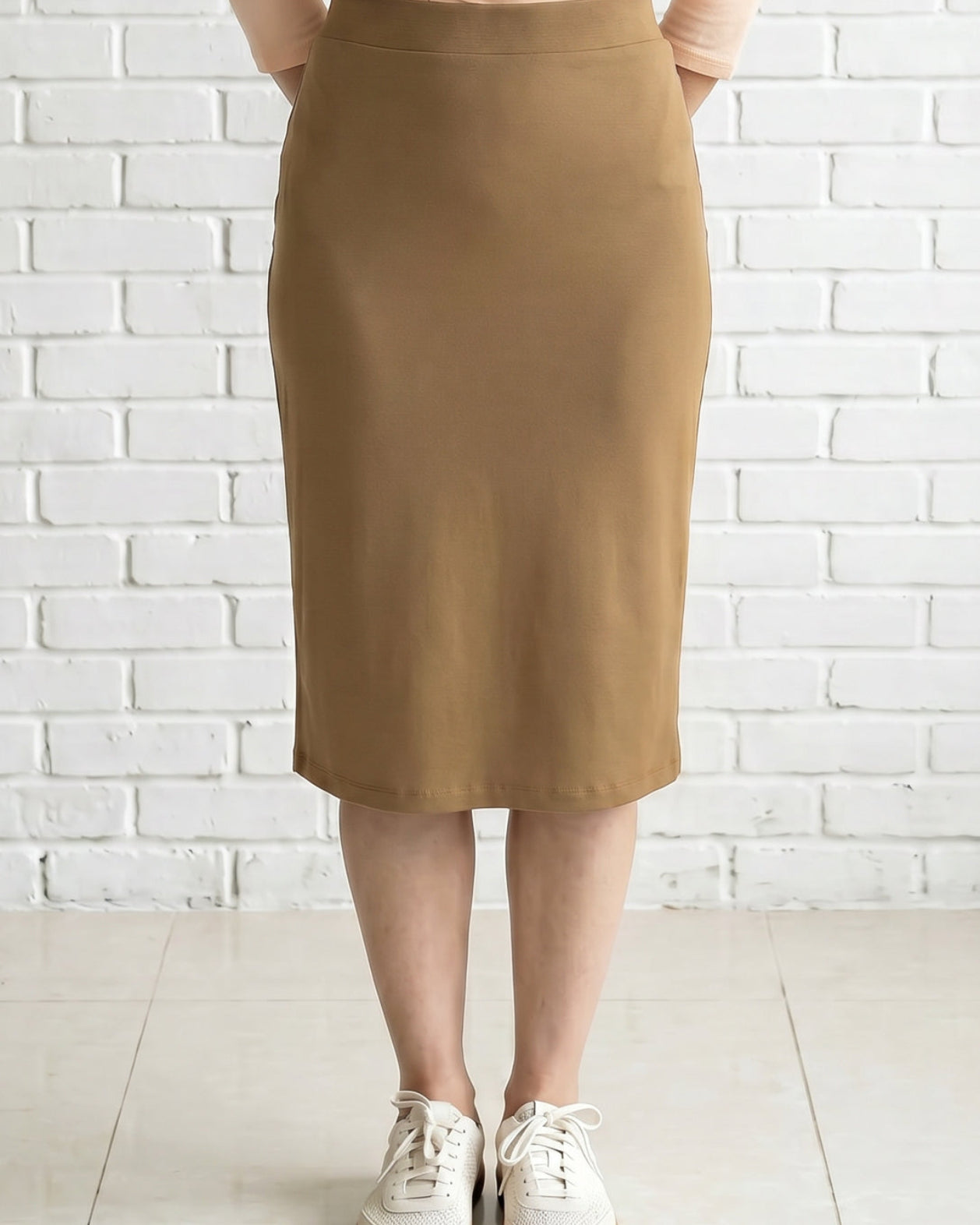 Model wearing Nuggles® 27" Relaxed Skirt in Camel
