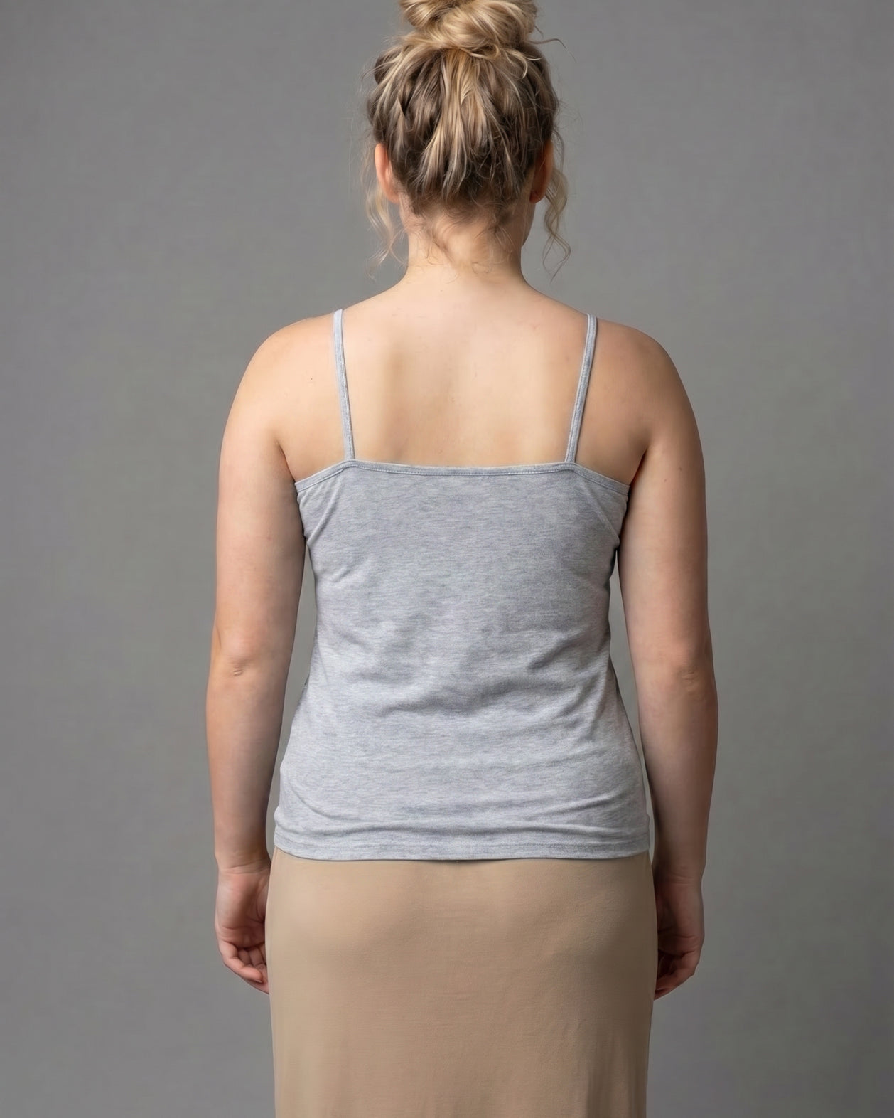 A photo of a women wearing a camisole in heather gray.