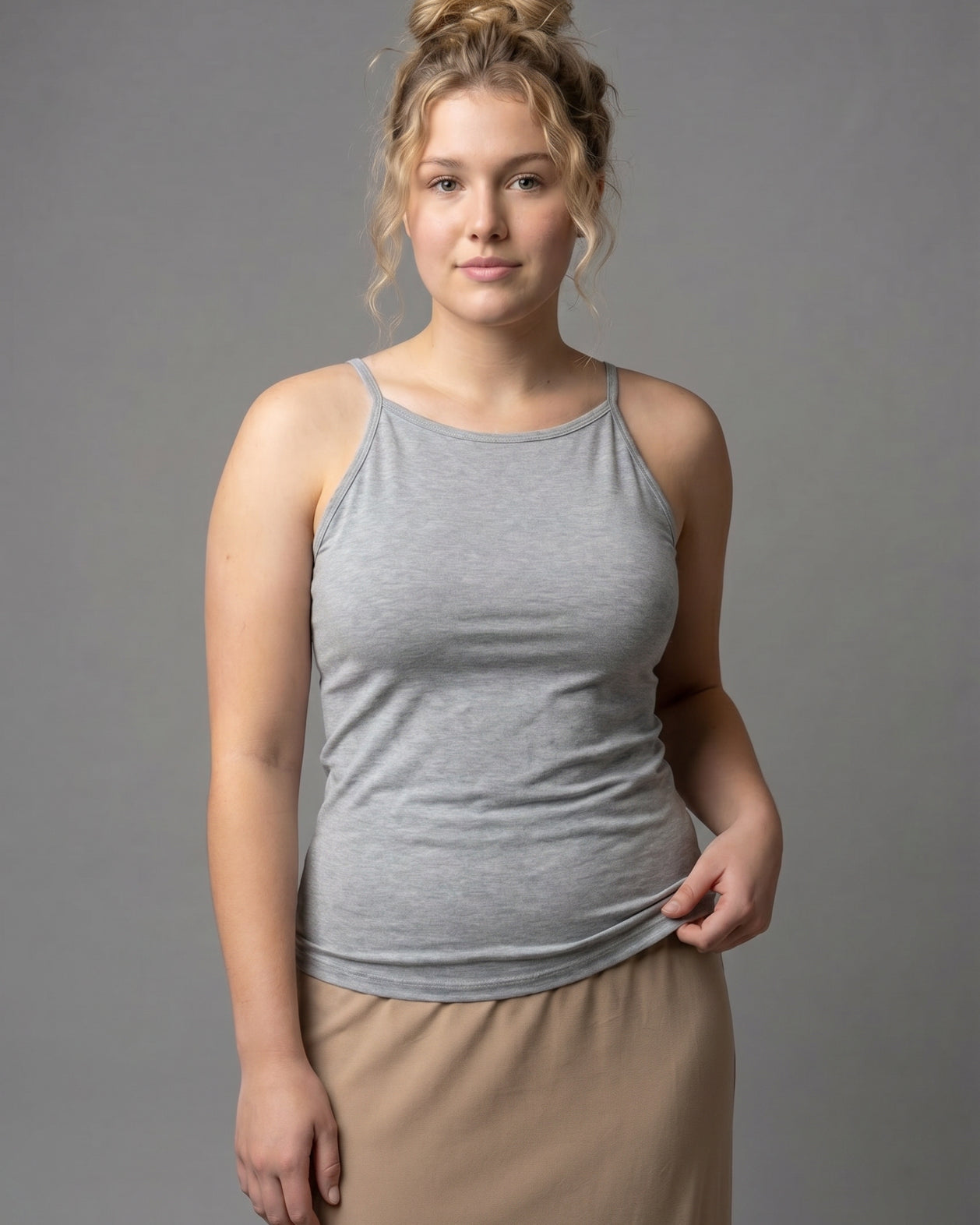 A photo of a women wearing a camisole in heather gray.