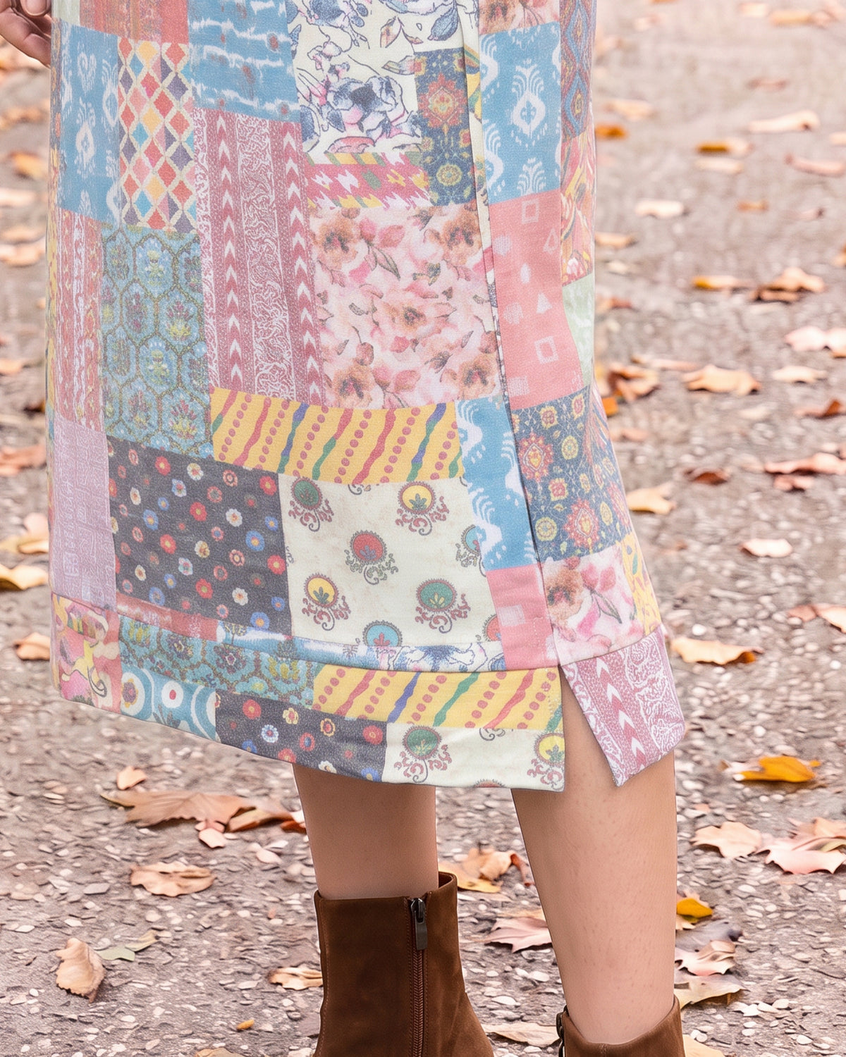 Nuggles® Hoodie Dress in Candy Lane, close-up of the banded hem and side slit above brown boots