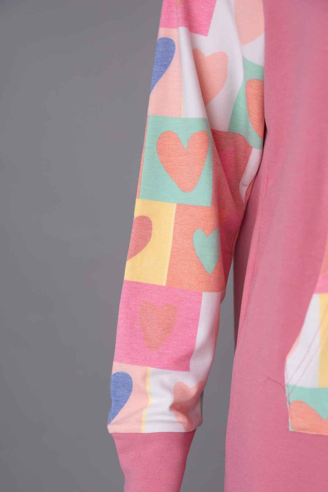 Model wearing Nuggles® Hoodie Dress in Candy Hearts