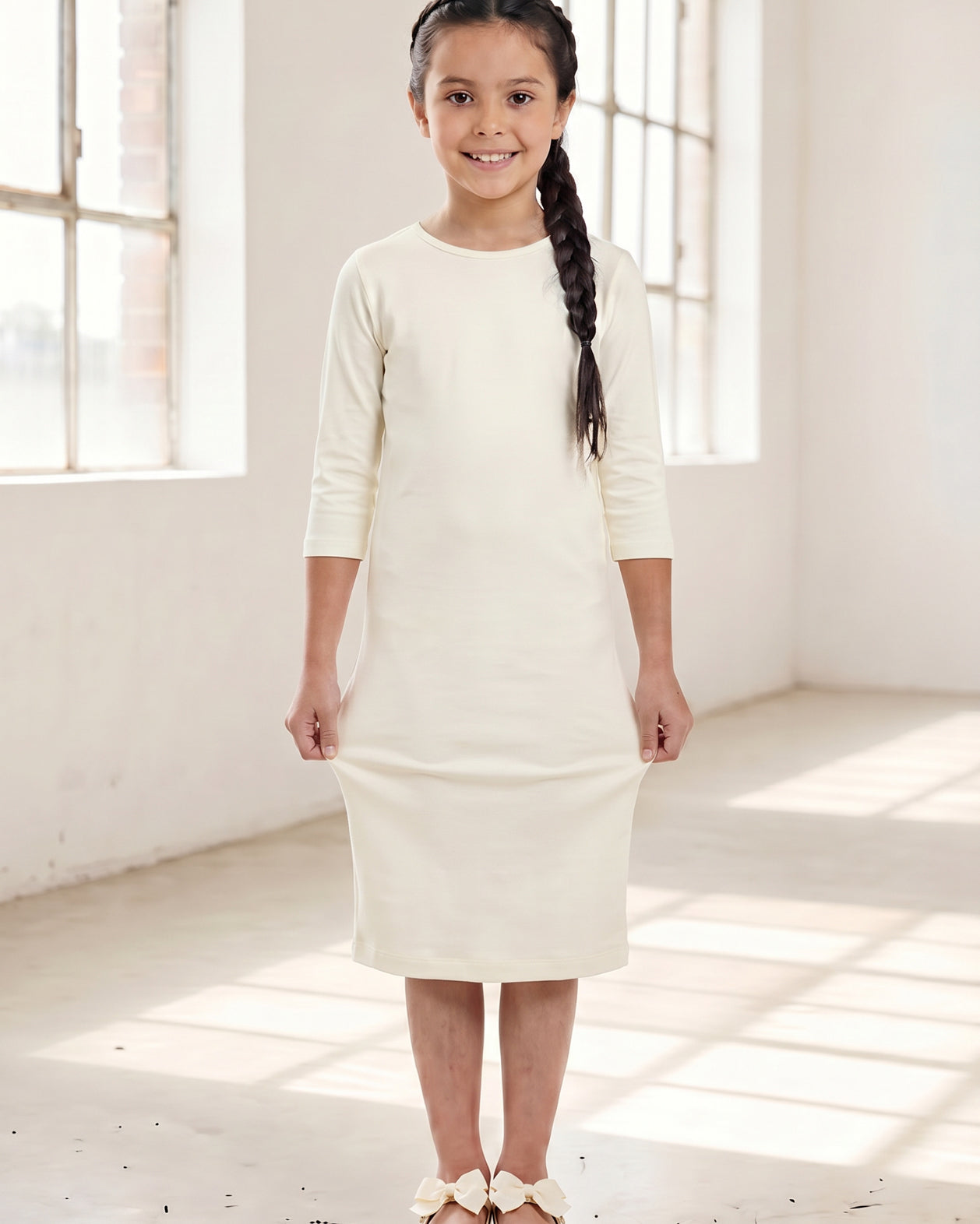Model wearing Nuggles® Girls Midi Layering Dress in Cream