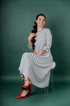 Model wearing the Nuggles® Gracie Dress, a modest A-line midi dress with ¾ sleeves and tie accents, made from soft knit fabric.