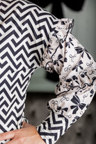 Nuggles® Rilynn Top – modest women’s printed top with ruffled sleeves and relaxed fit.