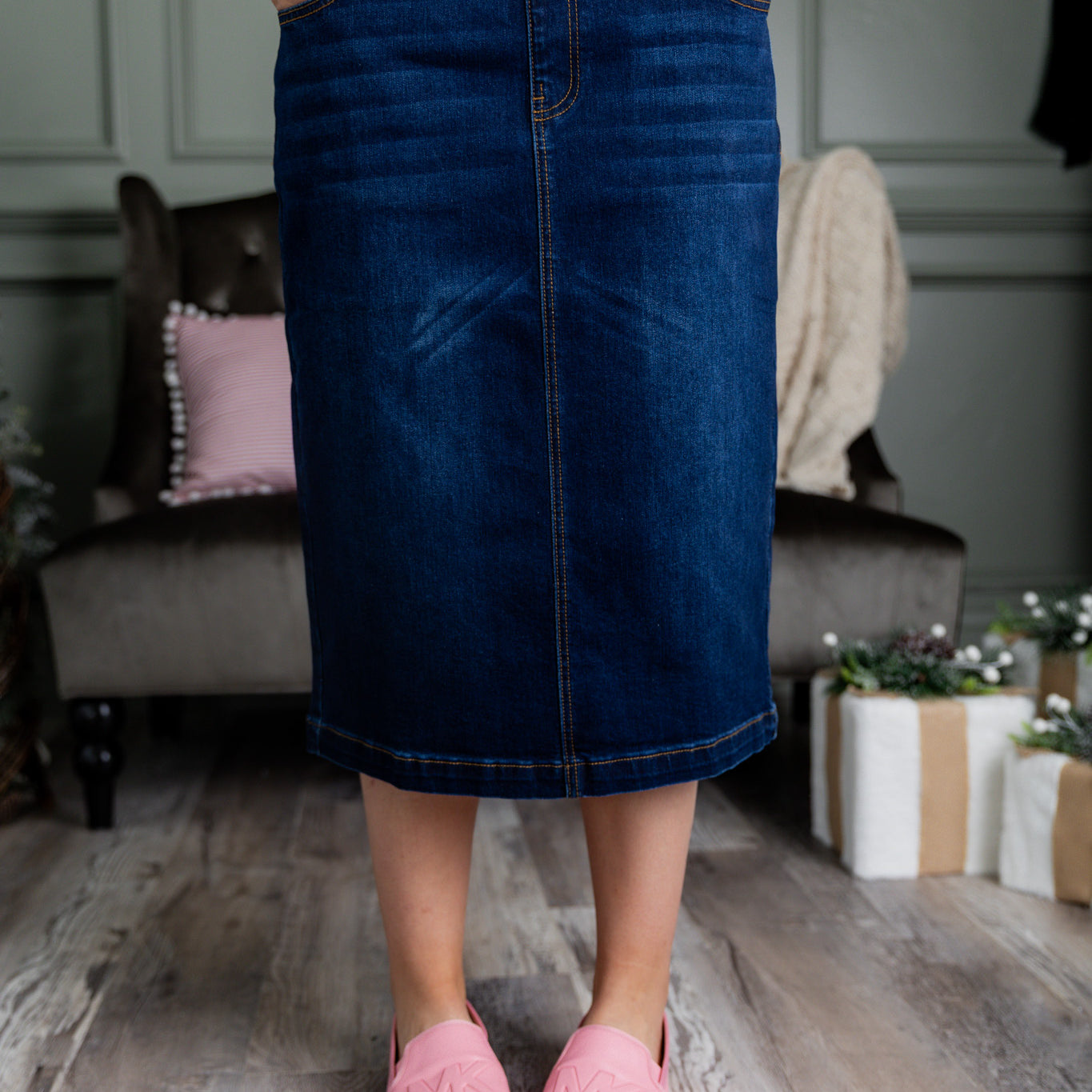 Nuggles® denim midi skirt with soft stretch fabric, wide elastic waistband, modest length, and functional pockets. Available in 27", 31", and 34" lengths.