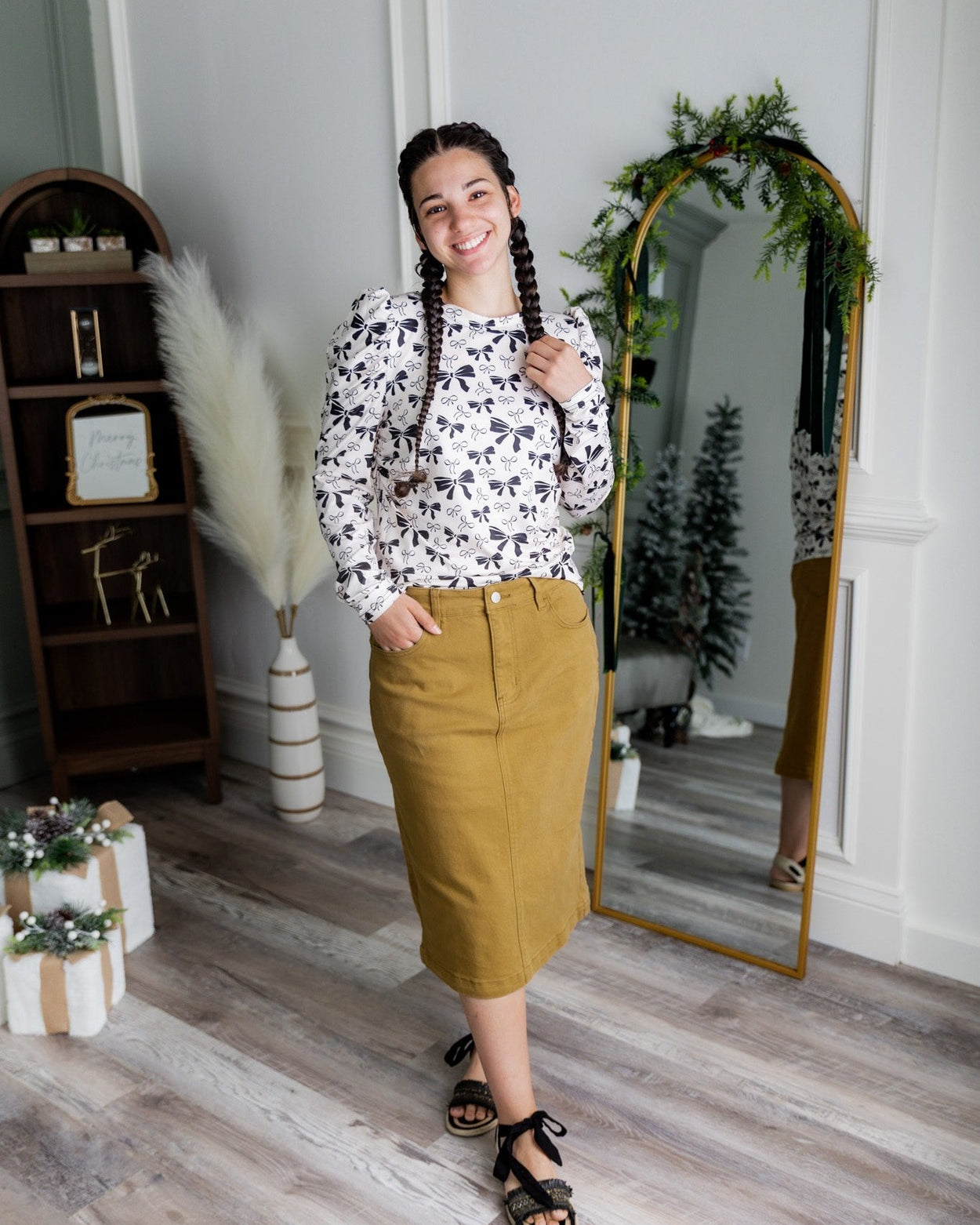 Nuggles® denim midi skirt with soft stretch fabric, wide elastic waistband, modest length, and functional pockets. Available in 27", 31", and 34" lengths.
