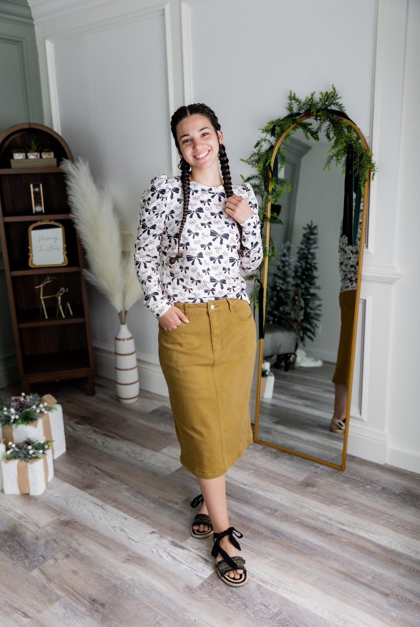 Nuggles® denim midi skirt with soft stretch fabric, wide elastic waistband, modest length, and functional pockets. Available in 27", 31", and 34" lengths.