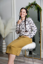 Nuggles® denim midi skirt with soft stretch fabric, wide elastic waistband, modest length, and functional pockets. Available in 27", 31", and 34" lengths.