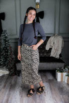 Nuggles® denim midi skirt with soft stretch fabric, wide elastic waistband, modest length, and functional pockets. Available in 27", 31", and 34" lengths.