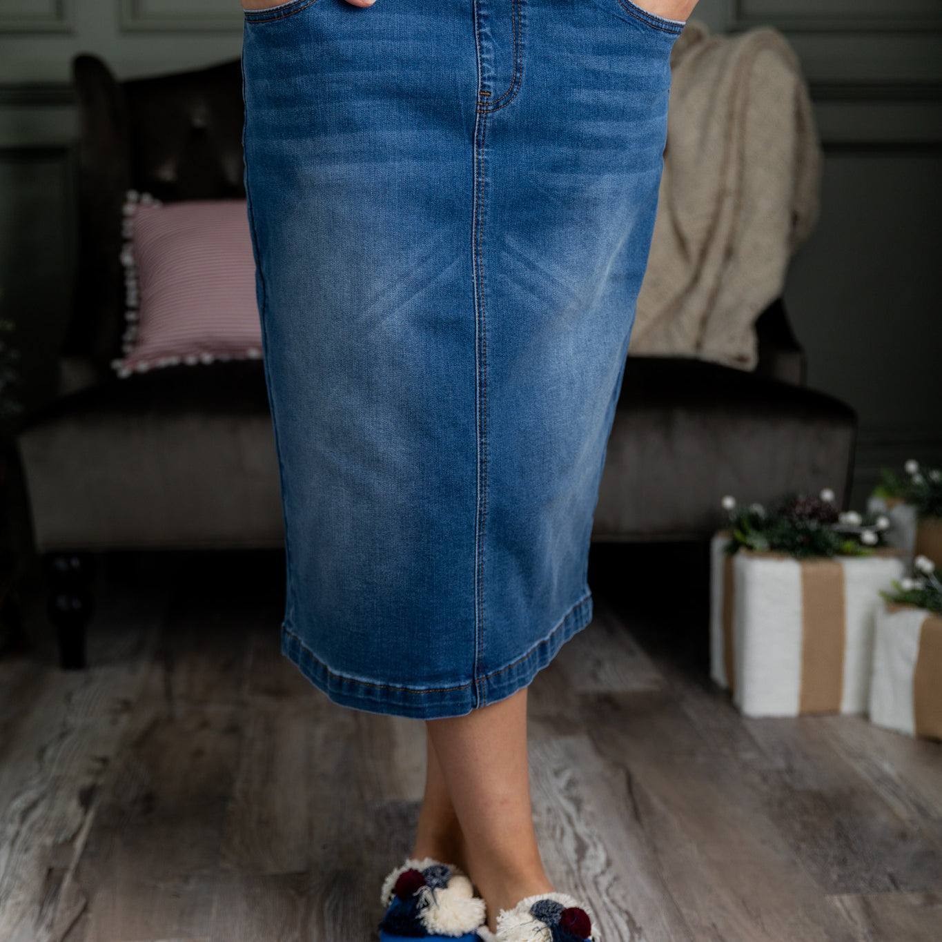 Nuggles® denim midi skirt with soft stretch fabric, wide elastic waistband, modest length, and functional pockets. Available in 27", 31", and 34" lengths.