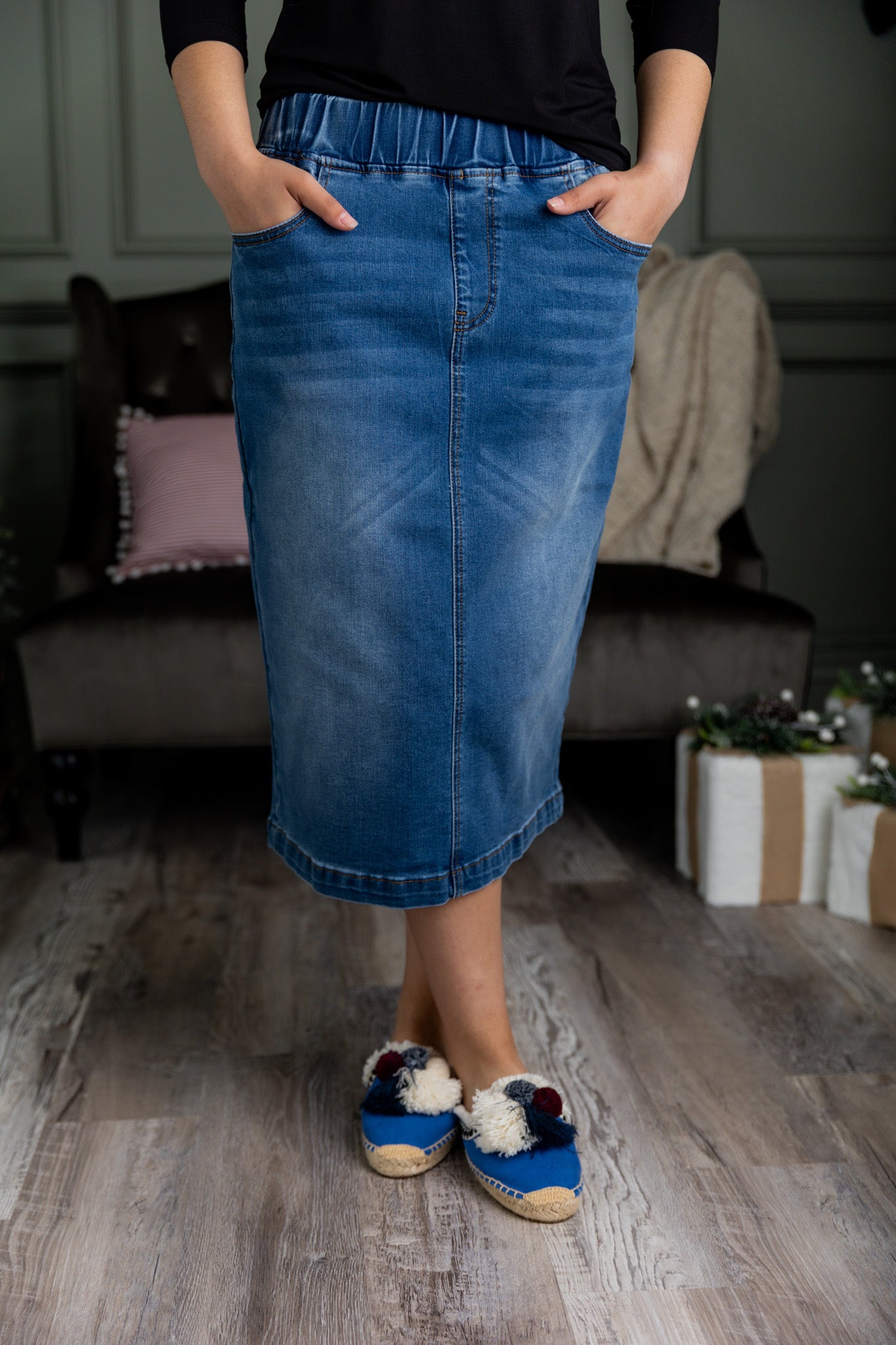 Nuggles® denim midi skirt with soft stretch fabric, wide elastic waistband, modest length, and functional pockets. Available in 27", 31", and 34" lengths.