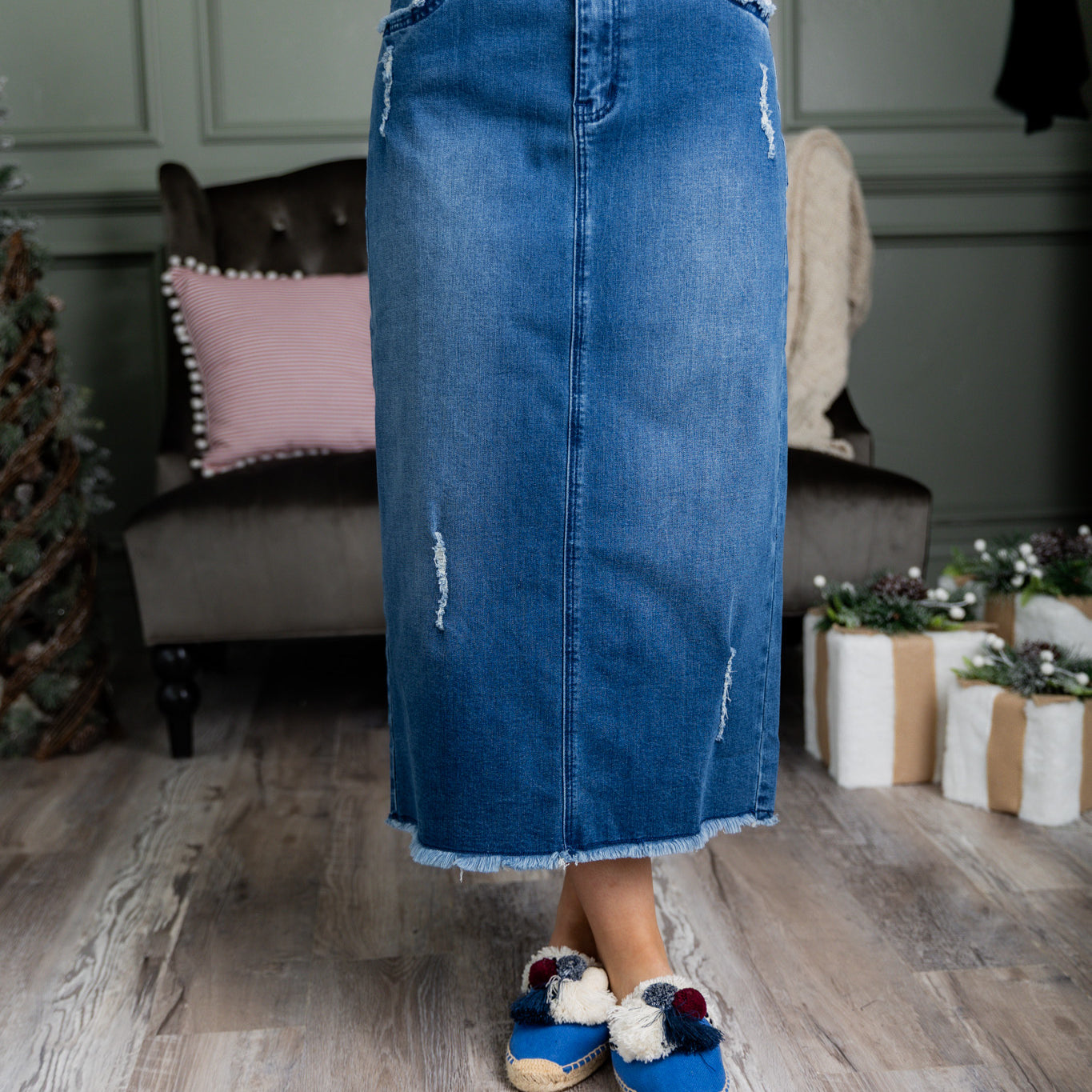 Nuggles® denim midi skirt with soft stretch fabric, wide elastic waistband, modest length, and functional pockets. Available in 27", 31", and 34" lengths.