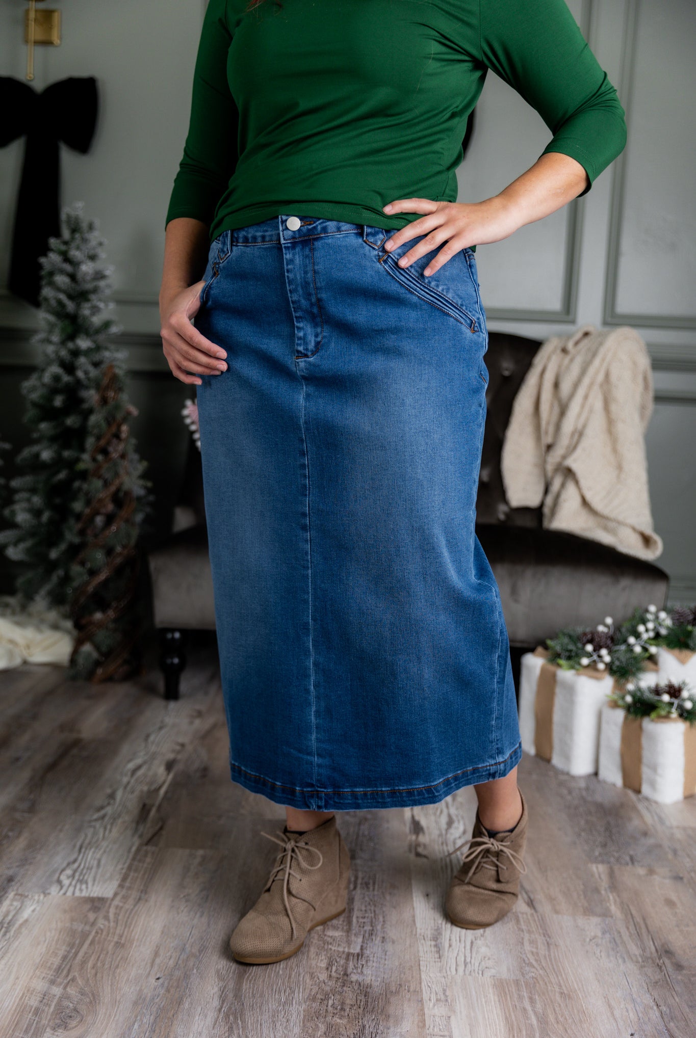 Nuggles® denim midi skirt with soft stretch fabric, wide elastic waistband, modest length, and functional pockets. Available in 27", 31", and 34" lengths.