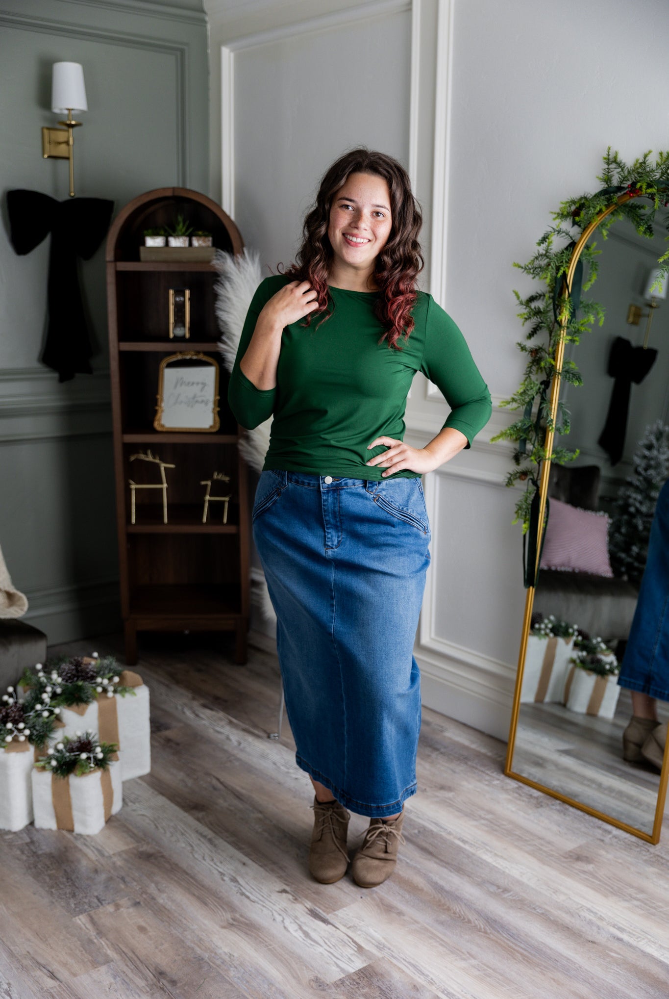 Nuggles® denim midi skirt with soft stretch fabric, wide elastic waistband, modest length, and functional pockets. Available in 27", 31", and 34" lengths.