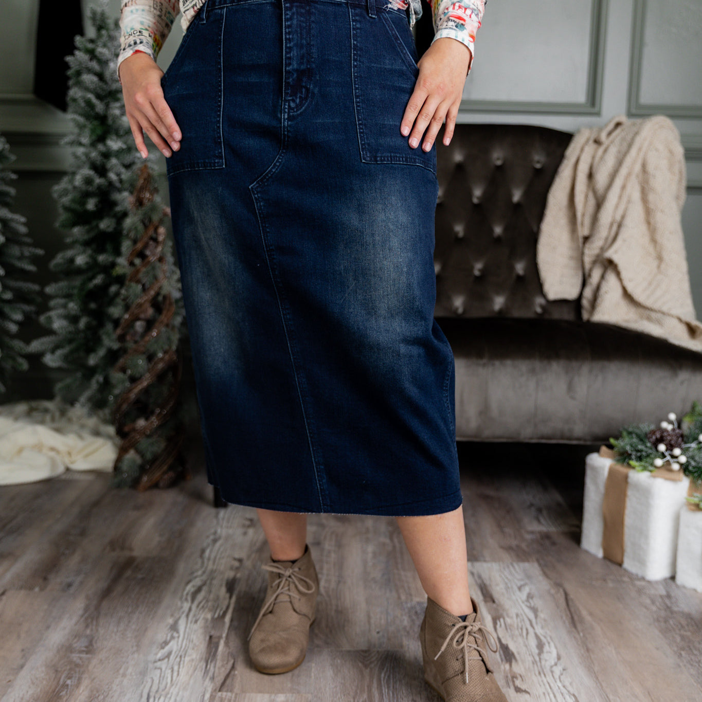 Nuggles® denim midi skirt with soft stretch fabric, wide elastic waistband, modest length, and functional pockets. Available in 27", 31", and 34" lengths.