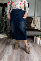 Nuggles® denim midi skirt with soft stretch fabric, wide elastic waistband, modest length, and functional pockets. Available in 27", 31", and 34" lengths.