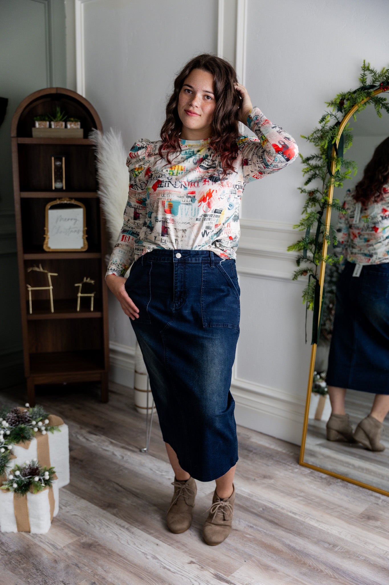 Nuggles® denim midi skirt with soft stretch fabric, wide elastic waistband, modest length, and functional pockets. Available in 27", 31", and 34" lengths.