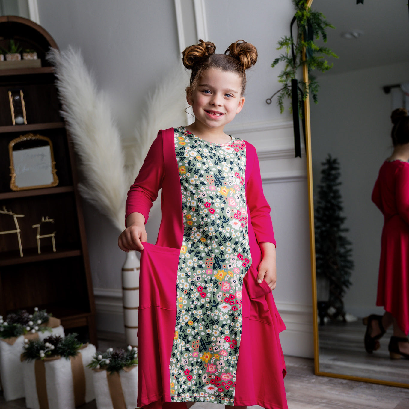 Nuggles® Raegan girls’ dress demonstrated on young model for product listing.