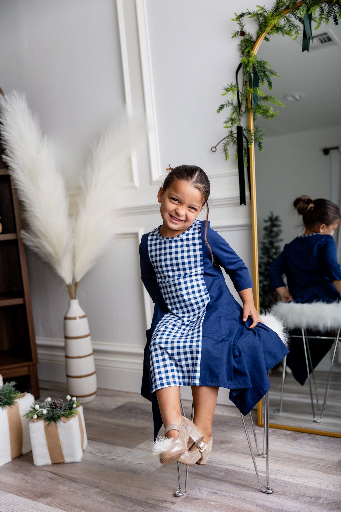 Nuggles® Raegan girls’ dress demonstrated on young model for product listing.