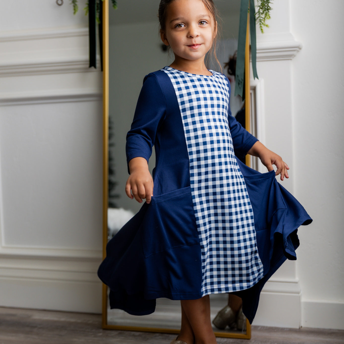 Nuggles® Raegan girls’ dress demonstrated on young model for product listing.