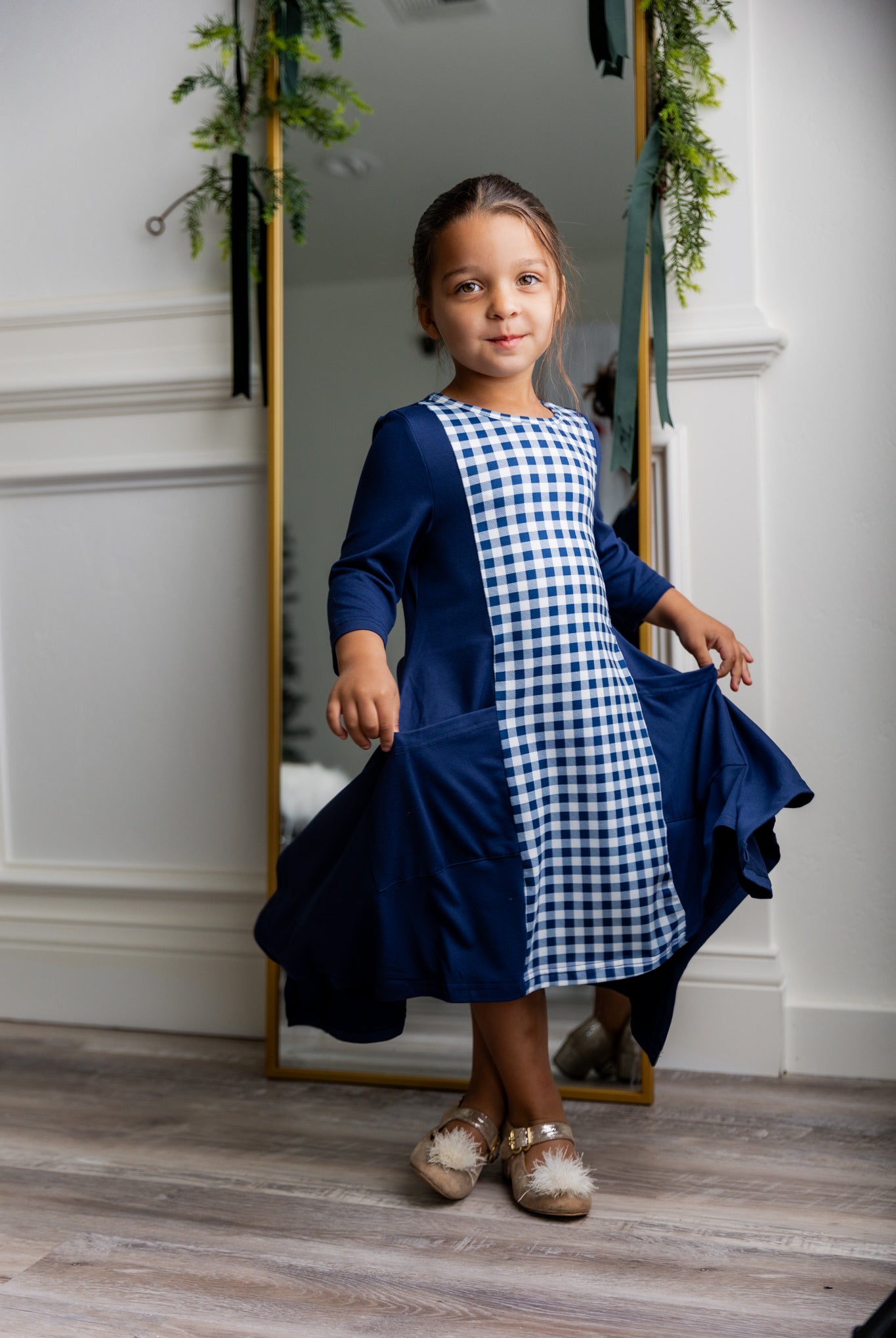 Nuggles® Raegan girls’ dress demonstrated on young model for product listing.