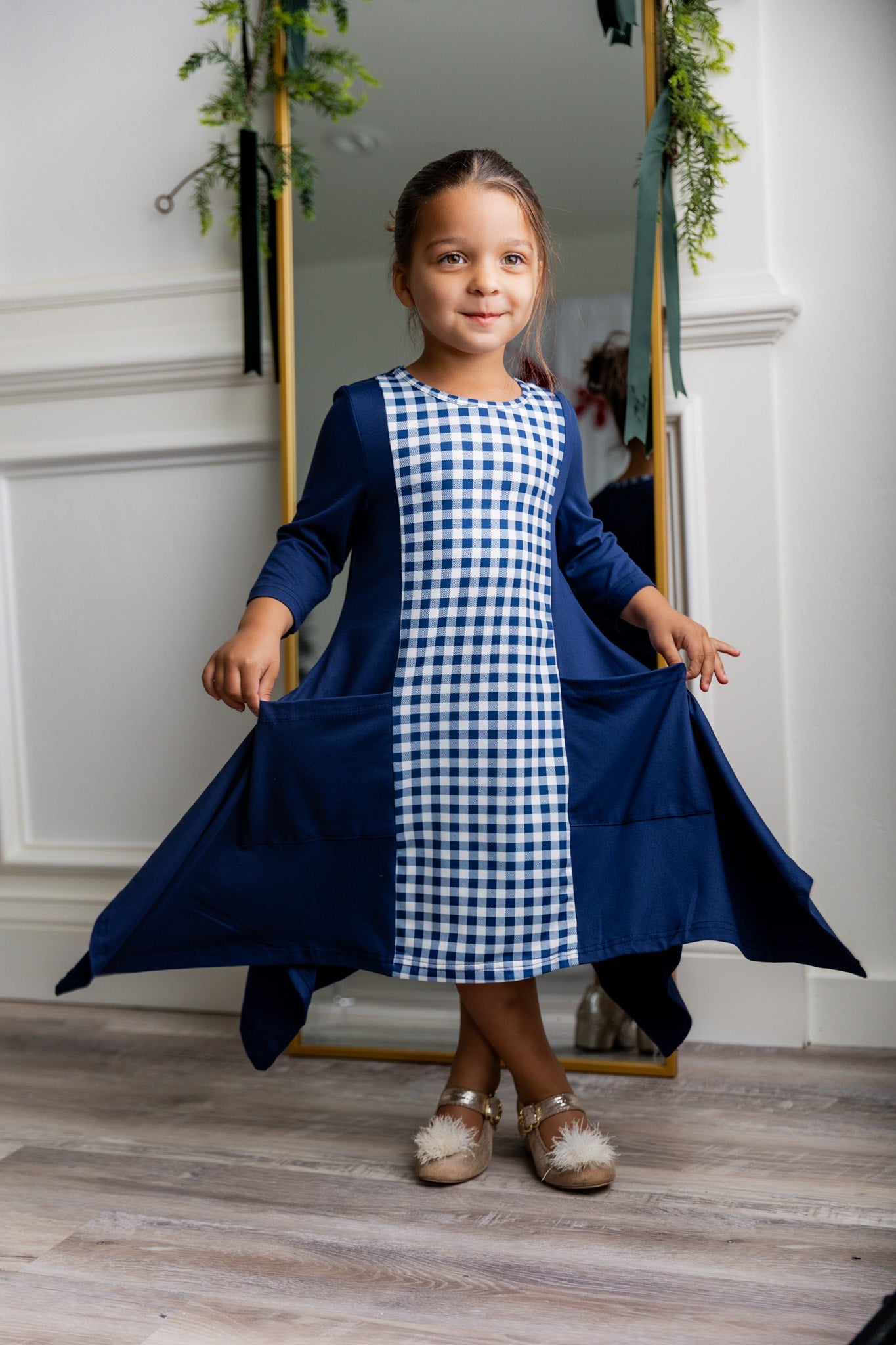 Nuggles® Raegan girls’ dress demonstrated on young model for product listing.