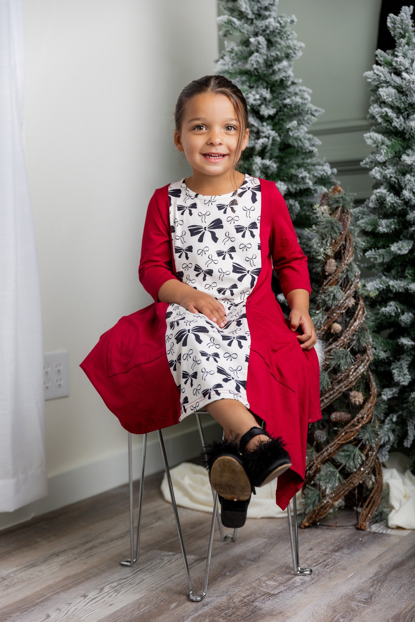 Nuggles® Raegan girls’ dress demonstrated on young model for product listing.