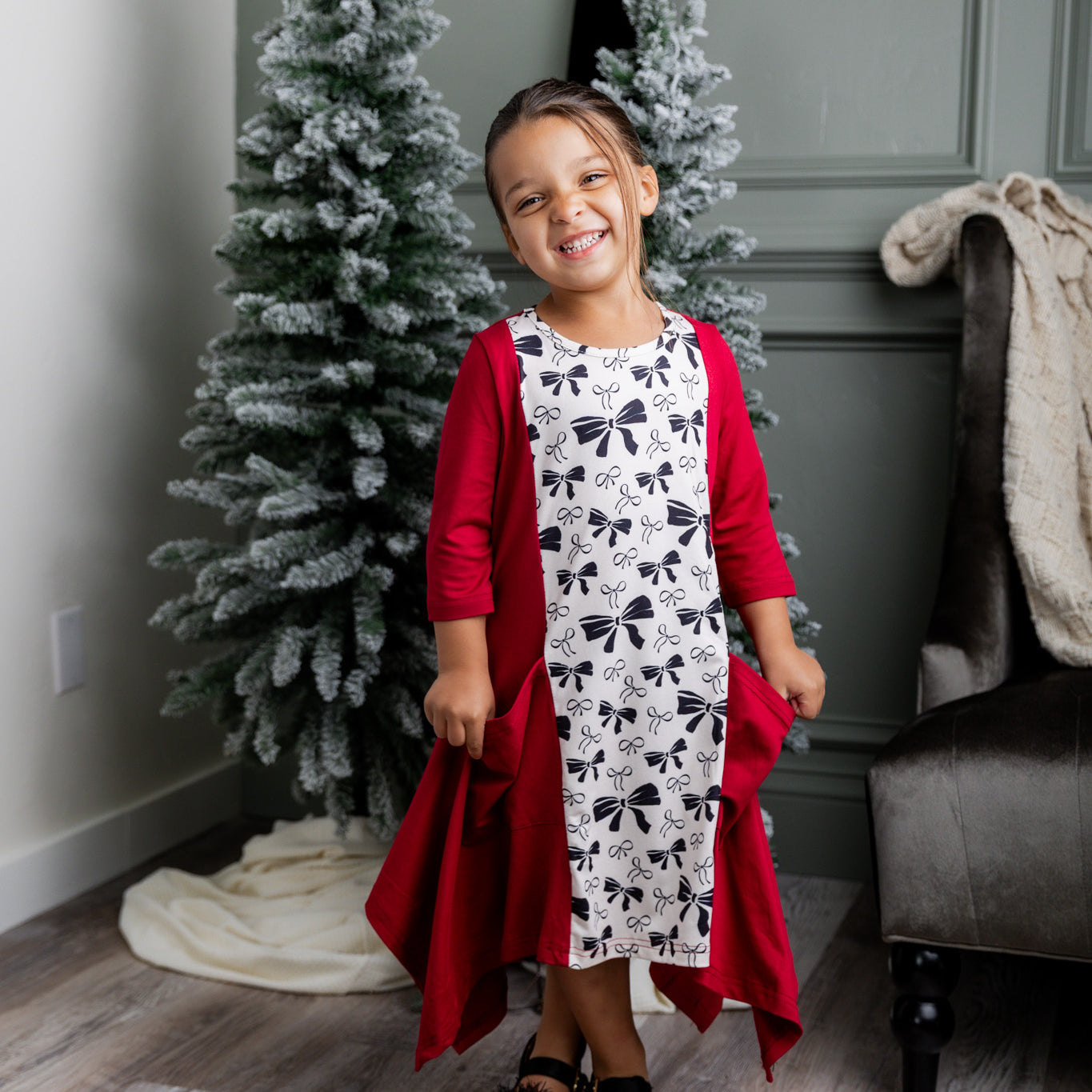 Nuggles® Raegan girls’ dress demonstrated on young model for product listing.