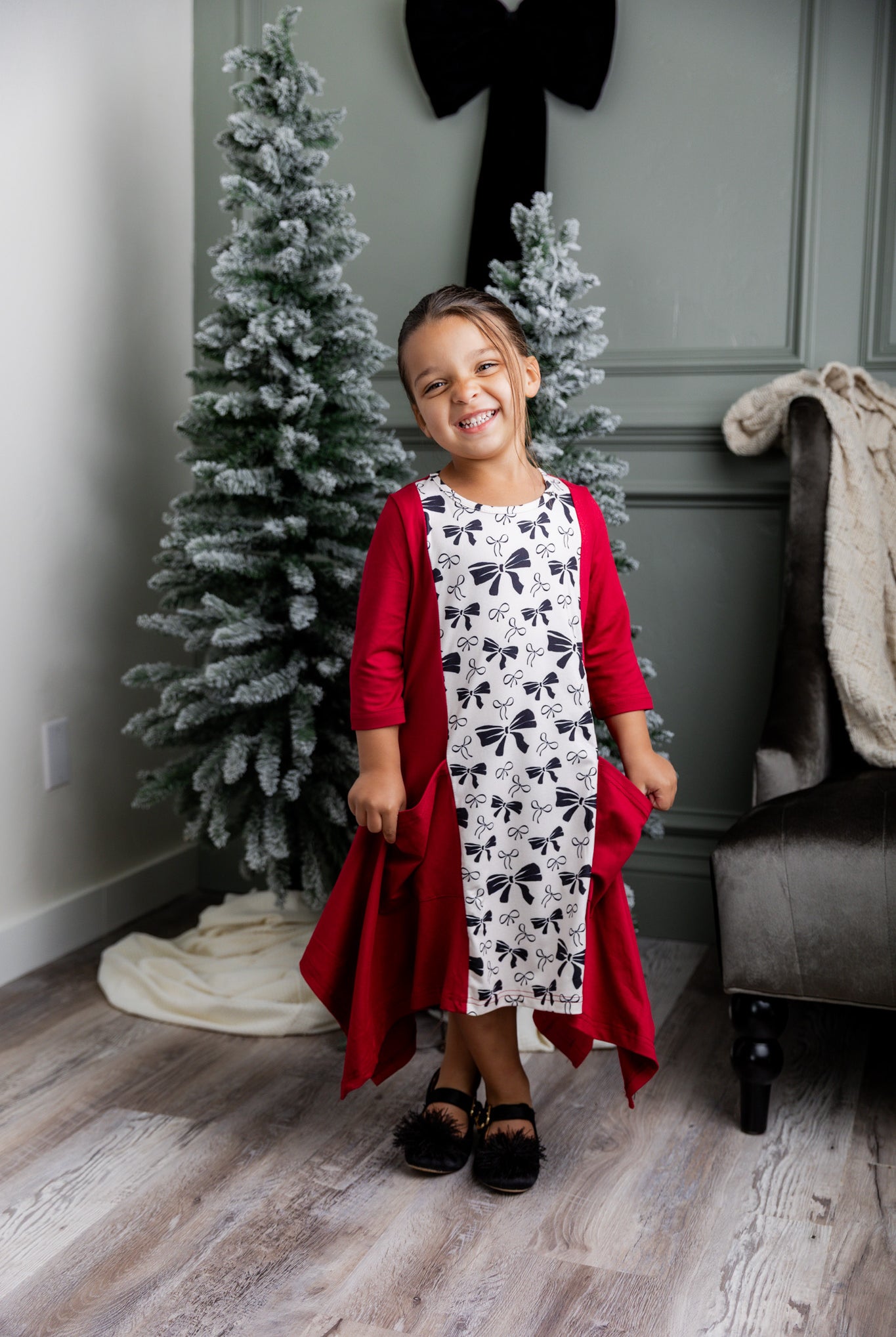 Nuggles® Raegan girls’ dress demonstrated on young model for product listing.