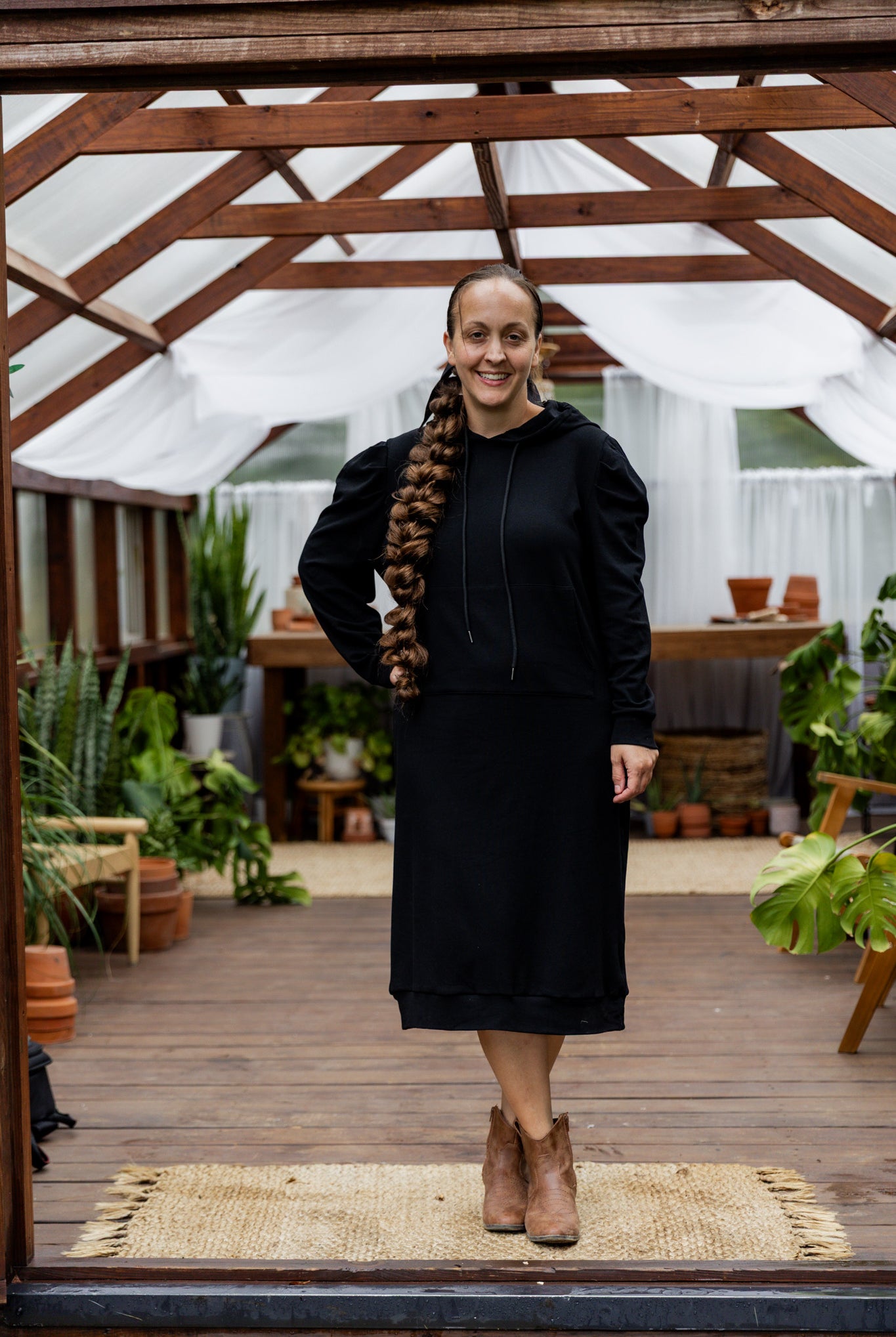 Model wearing Nuggles® Zoelle Dress in solid color, modest hoodie dress with puff sleeves.