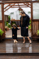 Young girl wearing Nuggles® Zoelle Dress in solid color, modest hoodie dress with puff sleeves.
