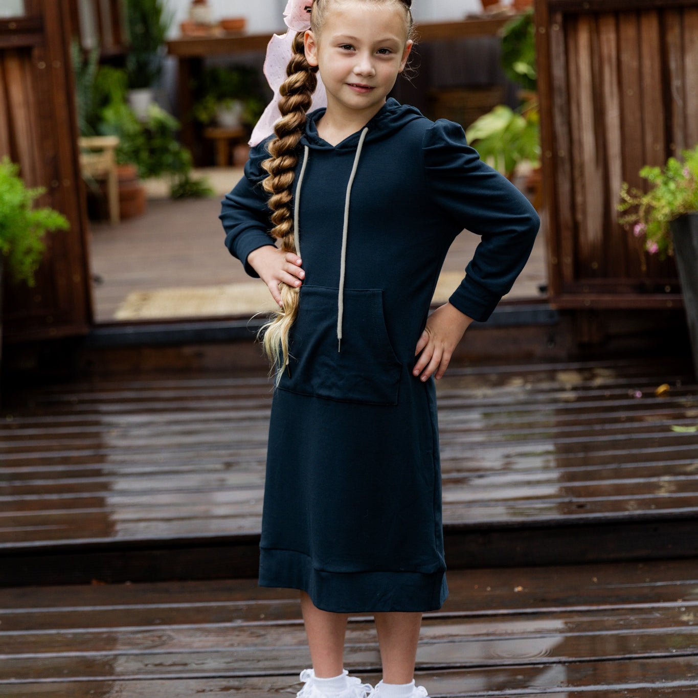 Young girl wearing Nuggles® Zoelle Dress in solid color, modest hoodie dress with puff sleeves.