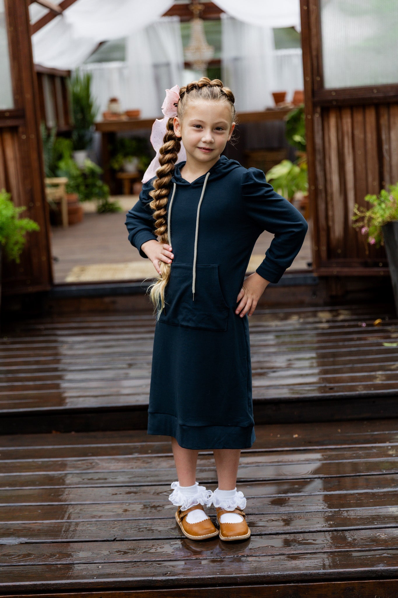 Young girl wearing Nuggles® Zoelle Dress in solid color, modest hoodie dress with puff sleeves.