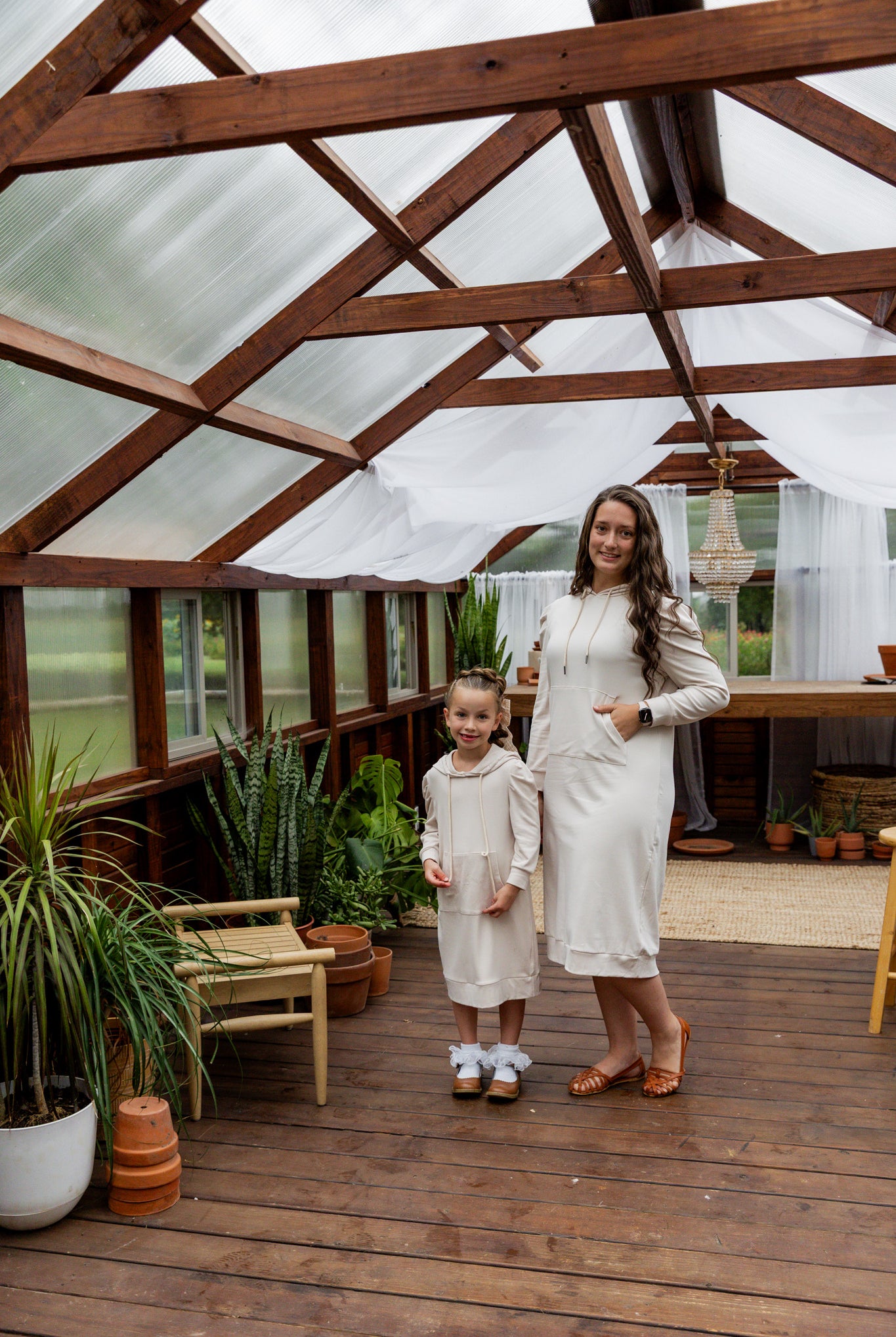 Model wearing Nuggles® Zoelle Dress in solid color, modest hoodie dress with puff sleeves.