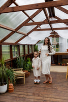 Young girl wearing Nuggles® Zoelle Dress in solid color, modest hoodie dress with puff sleeves.