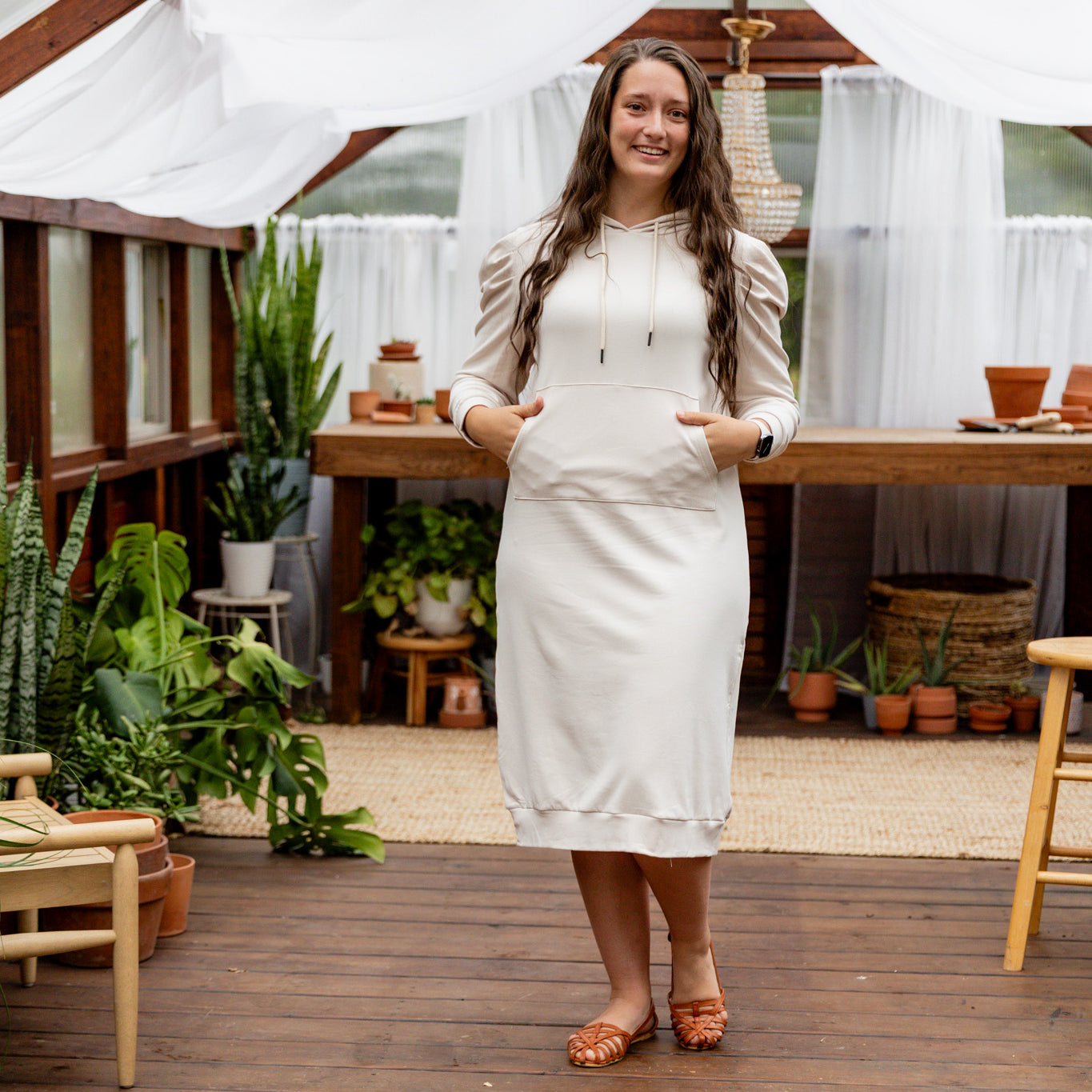 Model wearing Nuggles® Zoelle Dress in solid color, modest hoodie dress with puff sleeves.