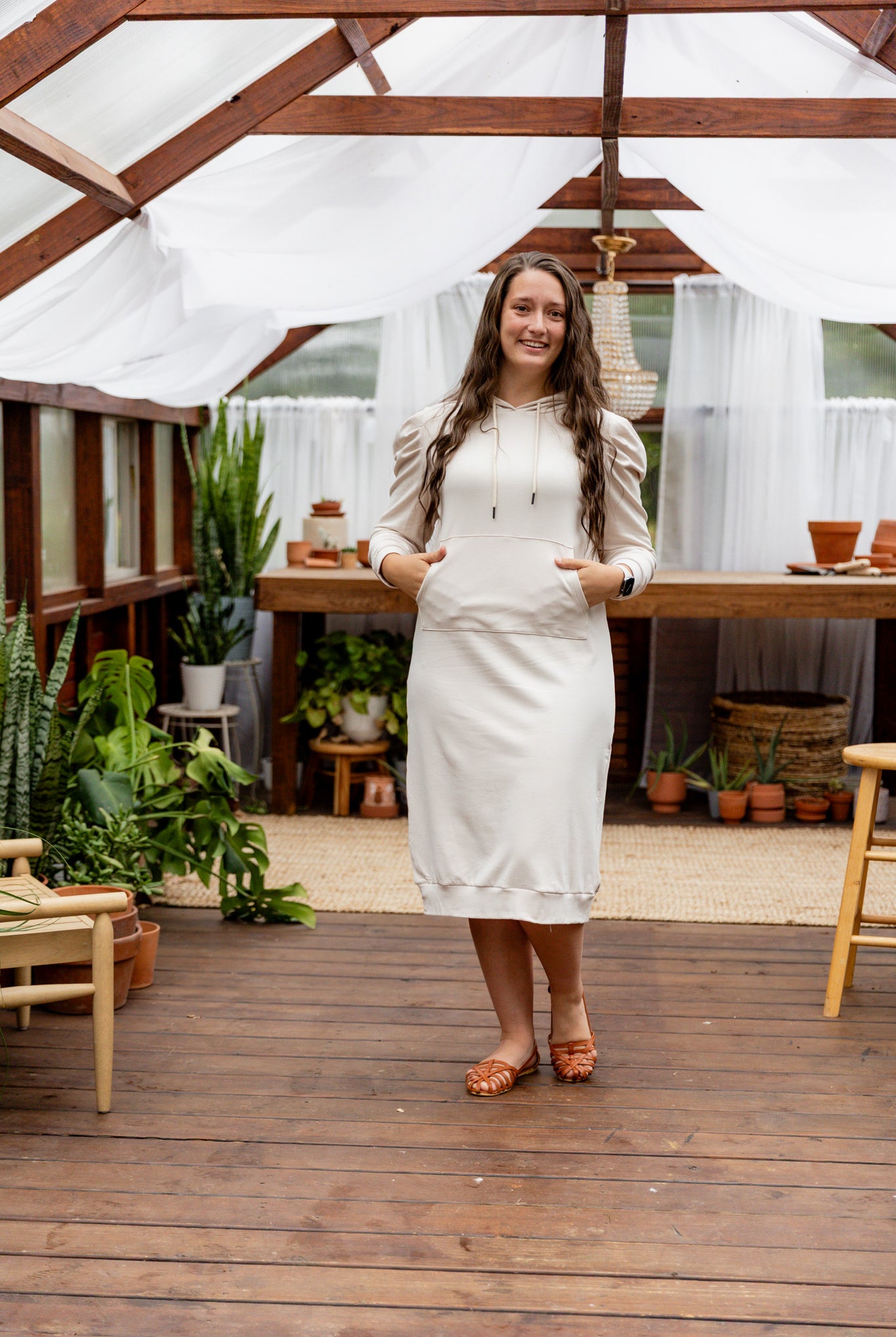 Model wearing Nuggles® Zoelle Dress in solid color, modest hoodie dress with puff sleeves.