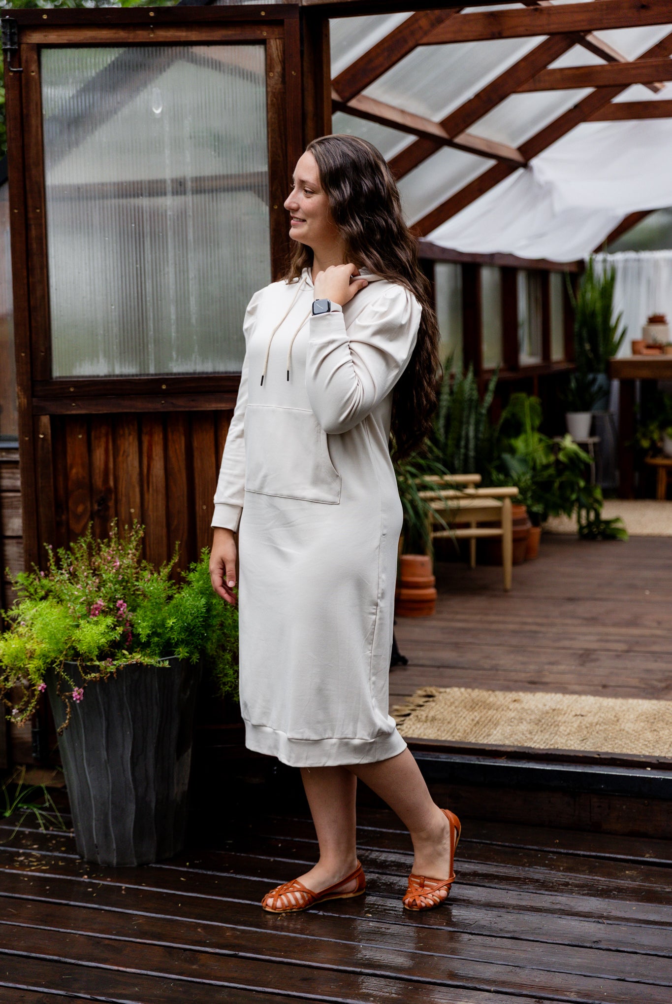 Model wearing Nuggles® Zoelle Dress in solid color, modest hoodie dress with puff sleeves.
