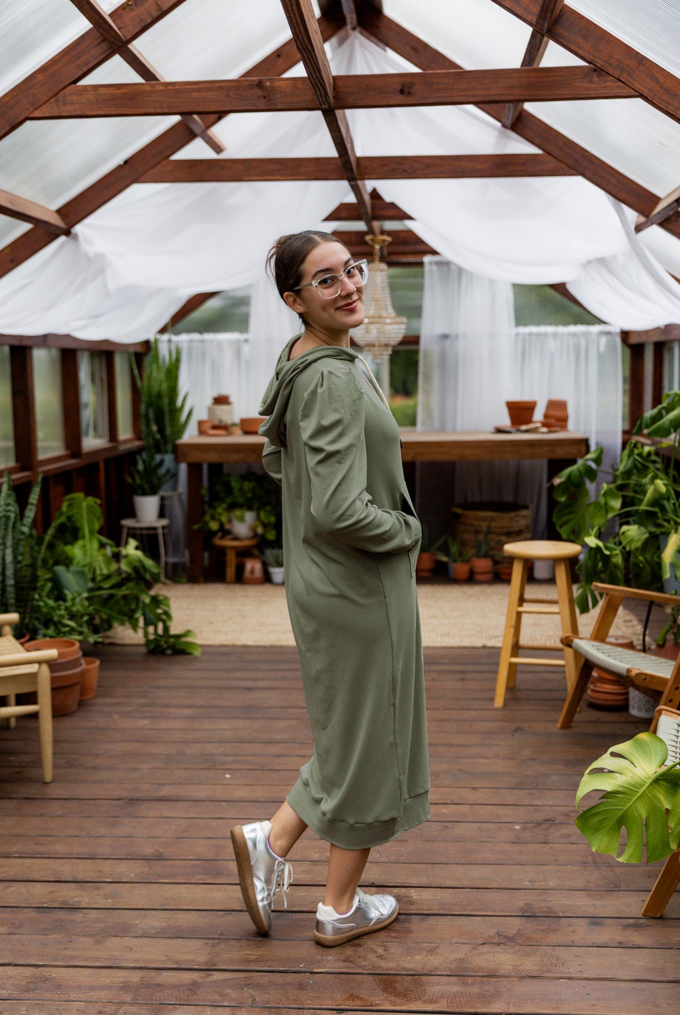 Model wearing Nuggles® Zoelle Dress in solid color, modest hoodie dress with puff sleeves.