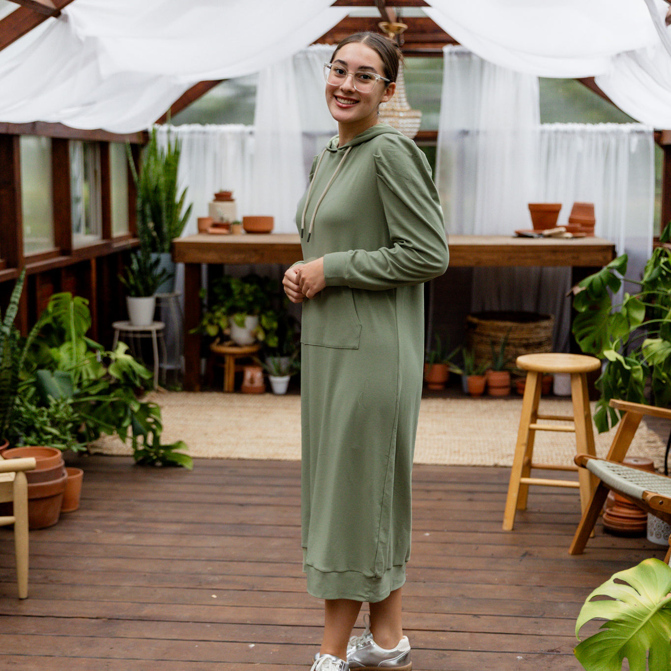 Model wearing Nuggles® Zoelle Dress in solid color, modest hoodie dress with puff sleeves.