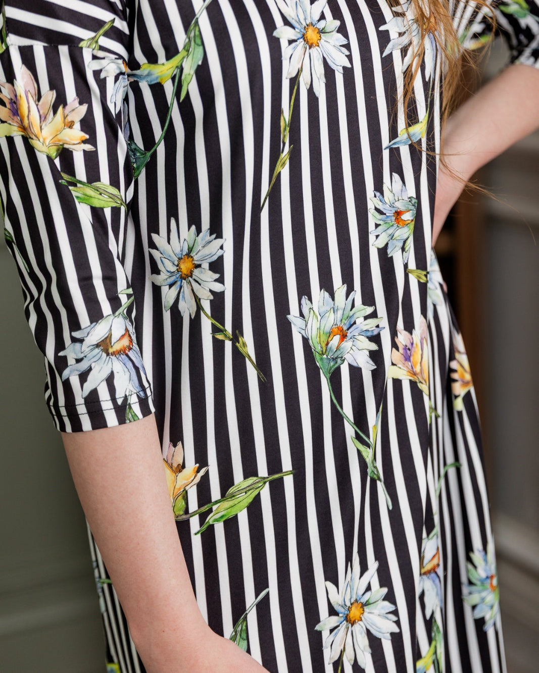 Model wearing the Nuggles® Heather Dress in Daisy Stripe