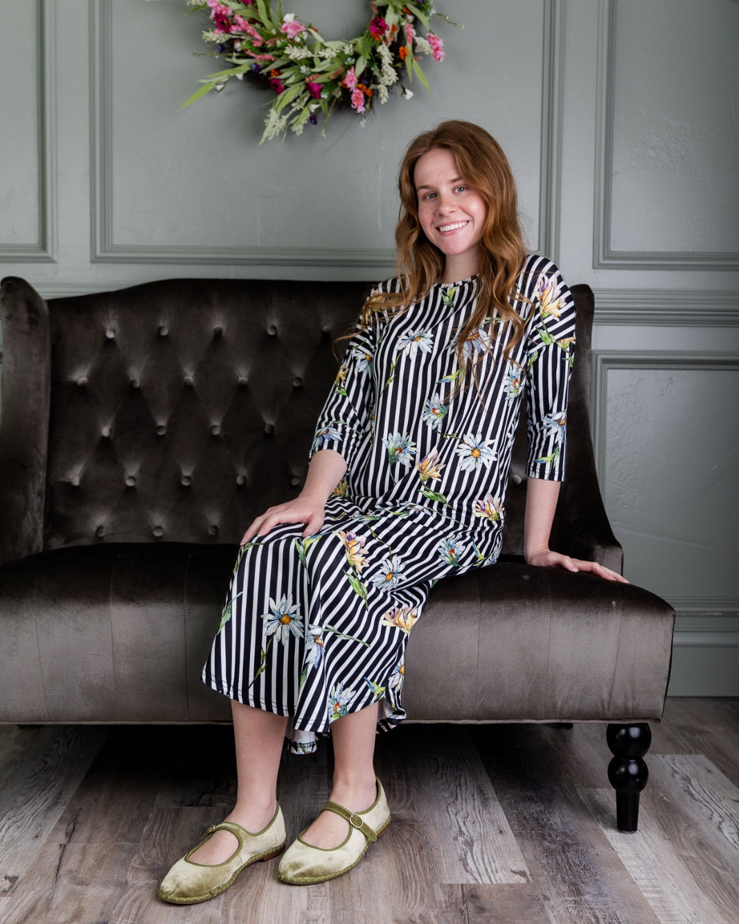 Model wearing the Nuggles® Heather Dress in Daisy Stripe