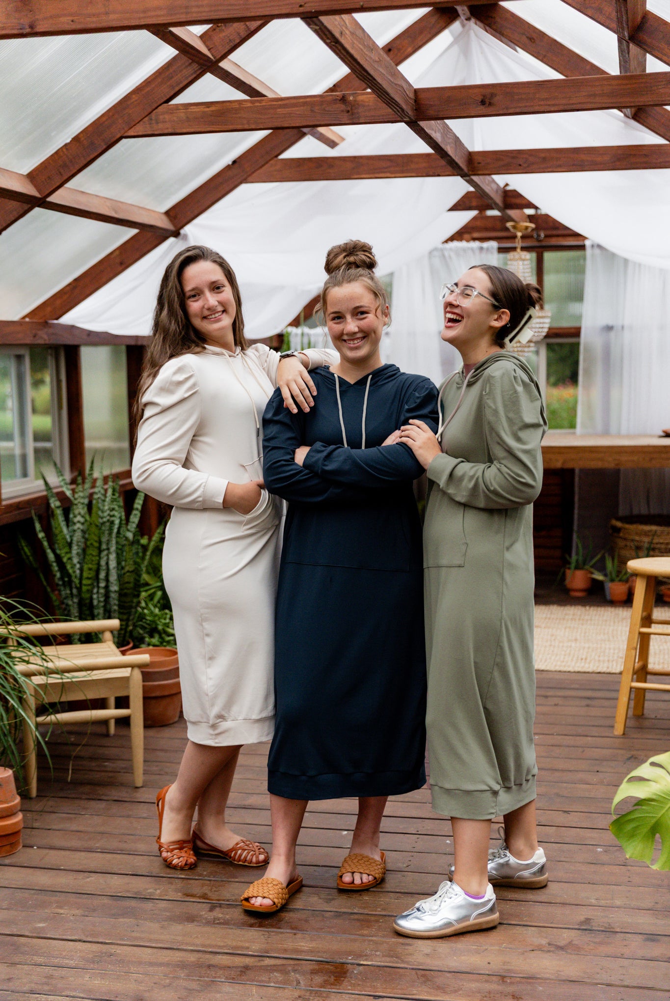 Model wearing Nuggles® Zoelle Dress in solid color, modest hoodie dress with puff sleeves.