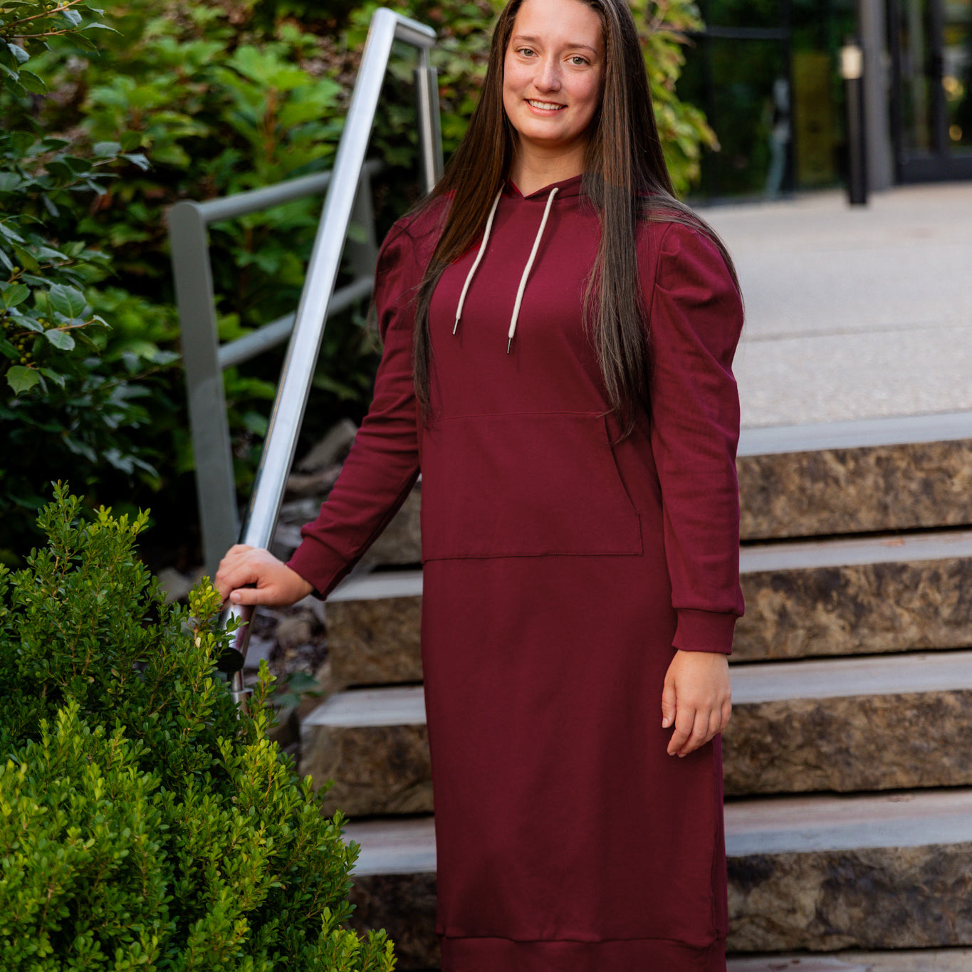 Model wearing Nuggles® Zoelle Dress in solid color, modest hoodie dress with puff sleeves.