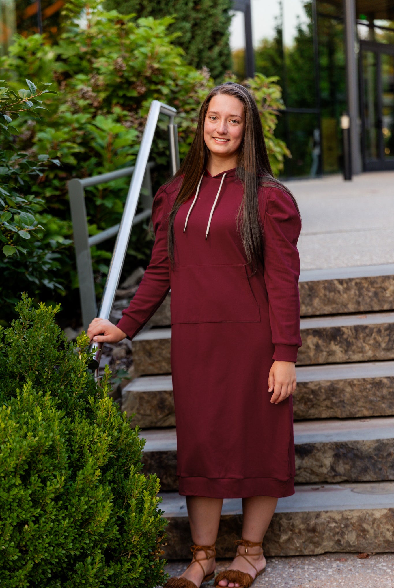 Model wearing Nuggles® Zoelle Dress in solid color, modest hoodie dress with puff sleeves.