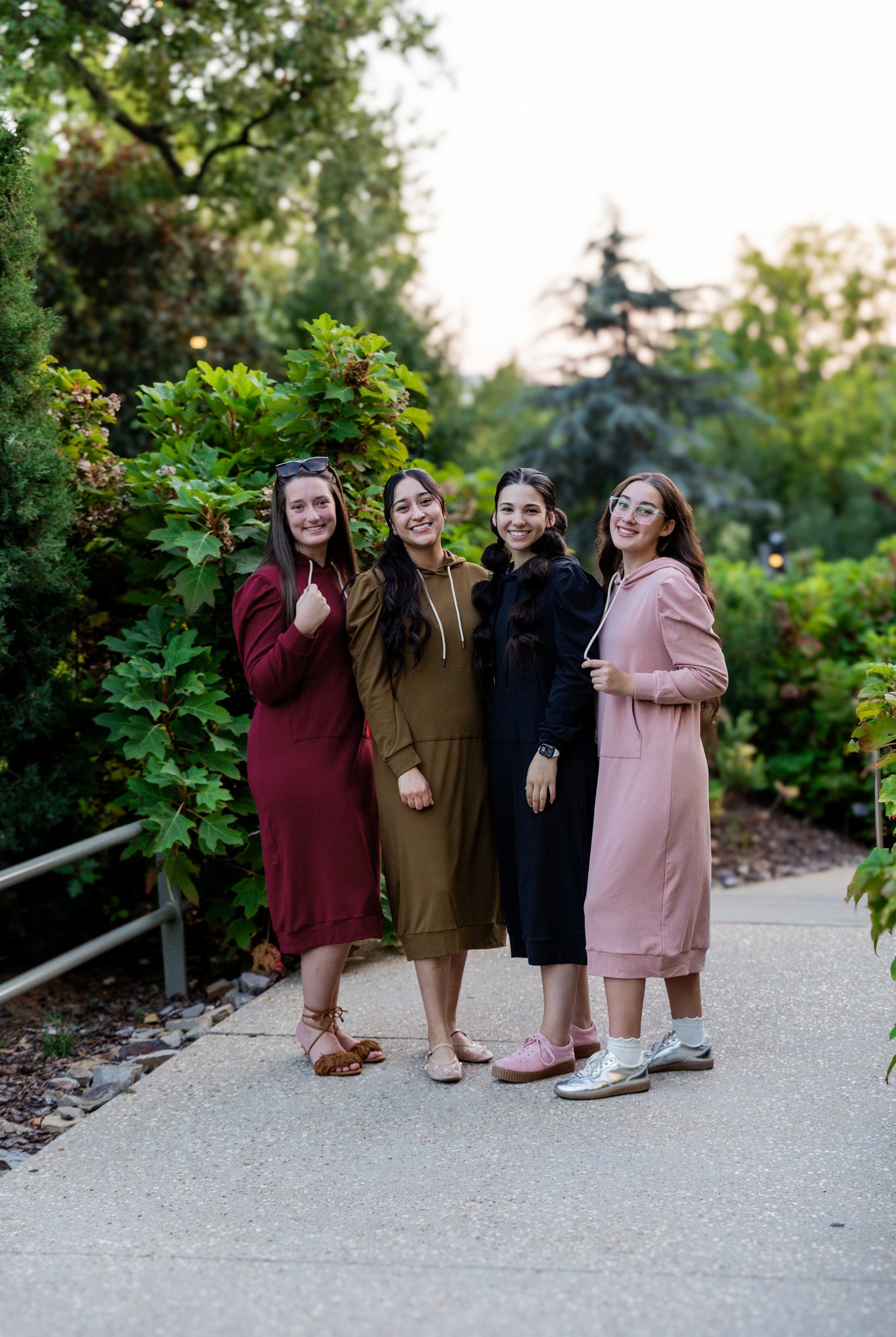 Model wearing Nuggles® Zoelle Dress in solid color, modest hoodie dress with puff sleeves.