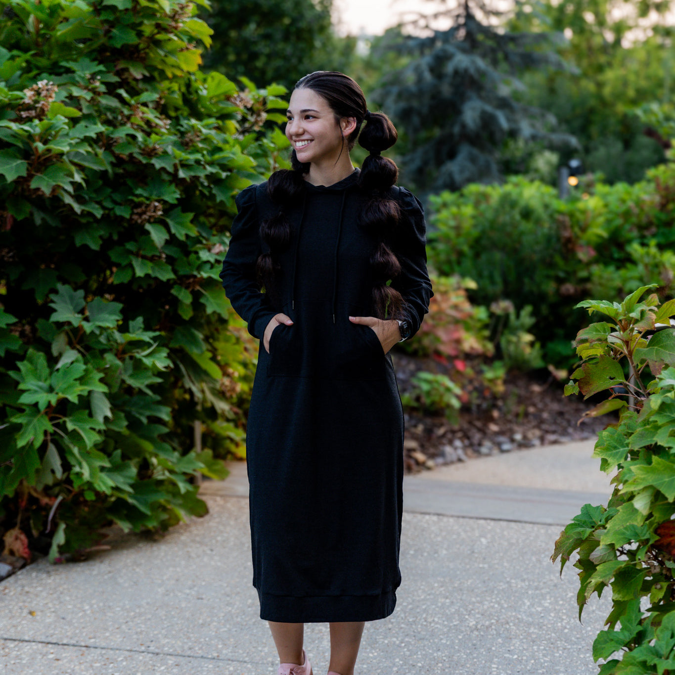 Model wearing Nuggles® Zoelle Dress in solid color, modest hoodie dress with puff sleeves.
